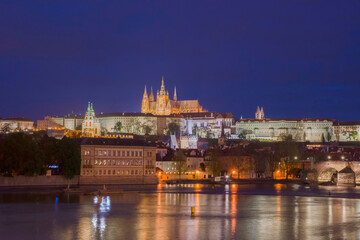 Fototapeta premium Vltava river with famous Hradcany castle and St. Vitus Cathedral in Prague, Czech Republic, by night