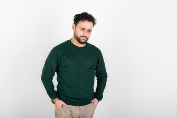 Fototapeta premium Portrait of man with depressed attitude looking down and hands in pockets