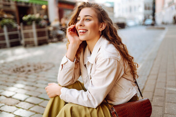 Outdoor portrait happy female tourist having good time wandering around town in summer. Fashion style. Tourist attraction.