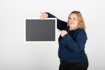 Naklejka premium Woman holding a black poster without text. Business template concept. White background