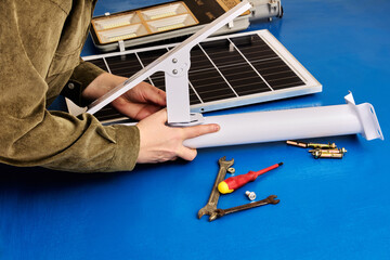Solar panel and LED light are prepared for installation on mounting bracket, DIY street lighting...