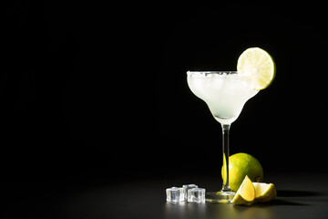 Margarita, alcoholic cocktail with lime, silver tequila, ice cubes and salt.