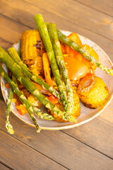 Plate with corn, green bean and bell peppers are cooked on the grill