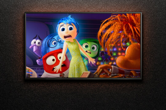 Inside Out 2 trailer or movie on TV screen. TV on black textured wall. Astana, Kazakhstan - July 3, 2024.