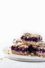 Baked oatmeal bars or crumble squares with fresh blueberry on white background with text space. Menu, recipe