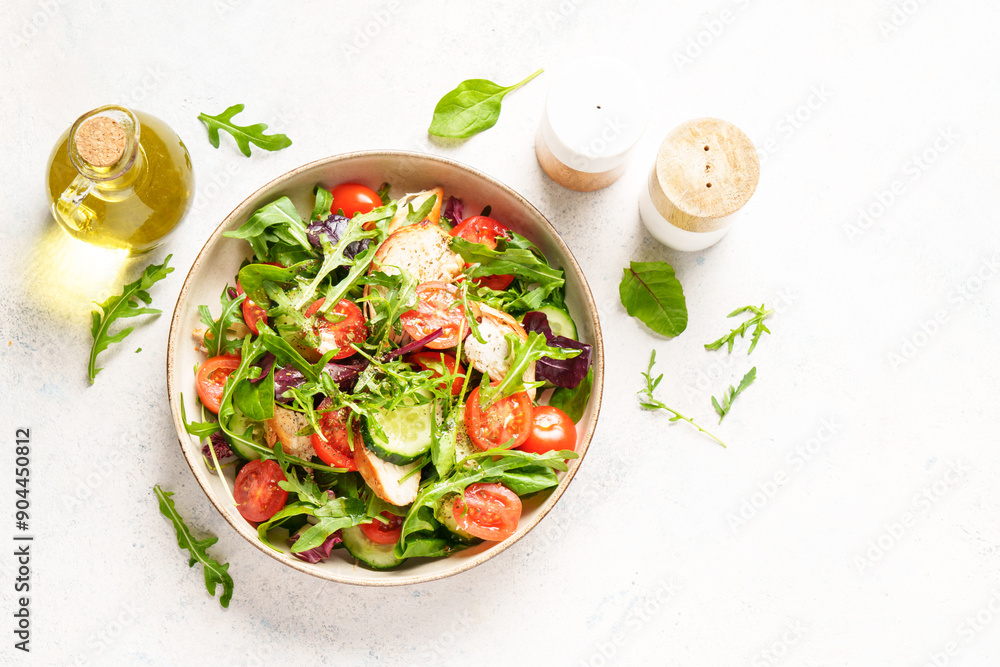 Wall mural green salad with baked chicken breast, fresh salad leaves and tomatoes. top view on white background