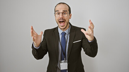 Excited man in business attire gestures with hands on white background