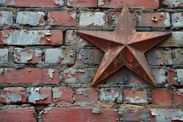 Close up of an old metal star decoration hanging on a weathered red brick wall, evoking history and nostalgia