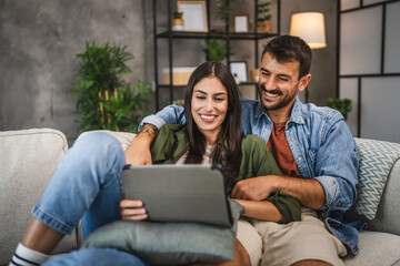 adult couple watch movie, a series on digital tablet at home