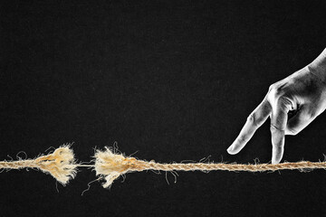 Fingers Walking Over Frayed Rope About to Break in Black and White on Textured Paper Background,...