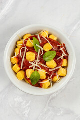 Gnocchi with tomato sauce, basil, cheese. italian dish, homemade food, pasta.