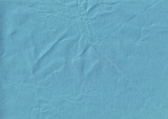 Blue crumpled paper texture background. Old weathered wrapper layout. Creased paper sheet backdrop.