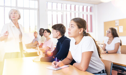 Attentive university students in advanced training courses in the auditorium