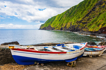 Fishing boats on bay shore at Farol do Arnel, Sao Miguel island, Azores, Portugal