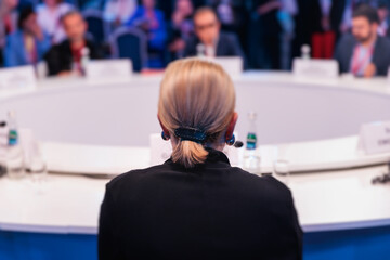 Group of women in business suits at round table, board meeting, roundtable talking and discussing at conference, female politicians and entrepreneurs, businesswomen dialog on forum, panel discussion