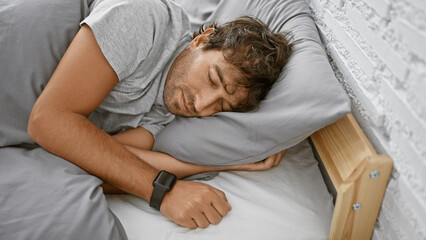 A handsome man sleeps soundly in a cozy bedroom showing relaxation and comfort.