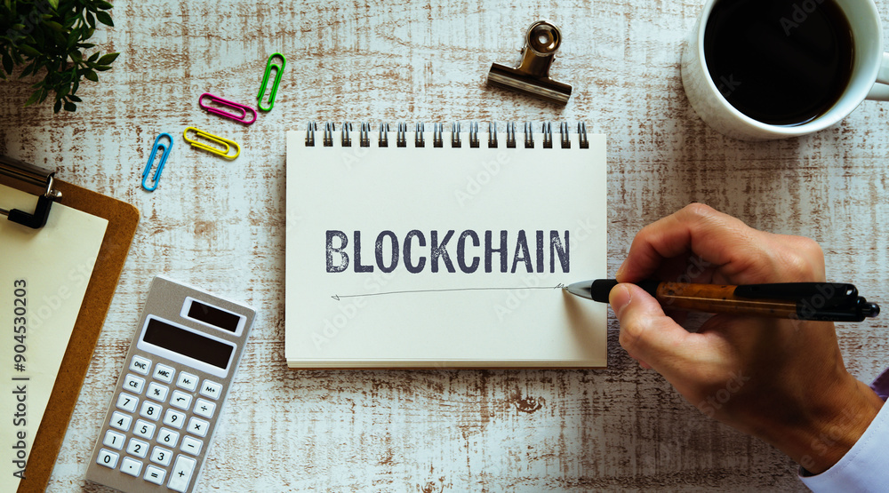 Poster there is notebook with the word blockchain. it is as an eye-catching image.