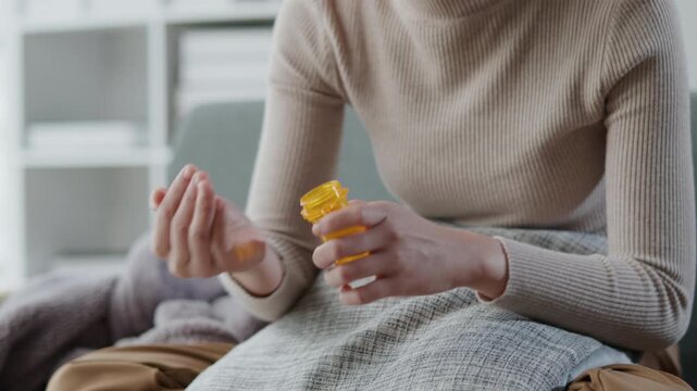 Sick woman is taking pills and water for helping healing illness as per prescription from doctor and pharmacy