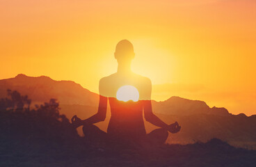 Double exposure of young woman practicing yoga meditation in nature