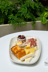 Elegant food photography of gourmet dish with wine and flowers in restaurant setting. Vertical photo. High quality photo