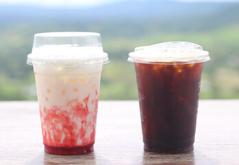 cup of coffee and strawberry fresh milk on table.