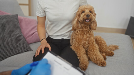 A man relaxes with his friendly poodle on a couch indoors, evoking a cozy, pet-friendly home atmosphere.