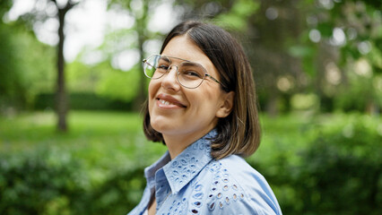 Young beautiful hispanic woman walking smiling at the park in Vienna