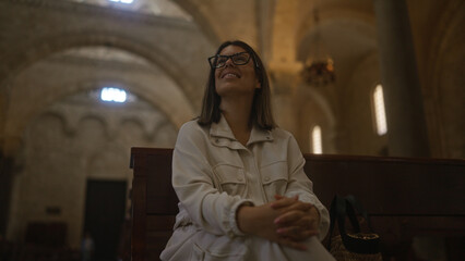 A young beautiful hispanic woman sits peacefully in an ancient italian christian church, smiling and reflecting deeply in the serene setting.