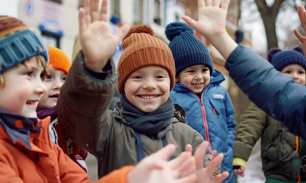 Children waving hello in winter