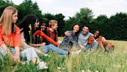 Fototapeta premium Multiethnic happy group of people having fun at park city outdoors during summer, spring day