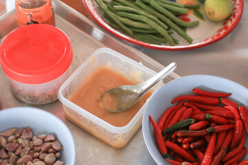 Palm sugar, red chili, garlic preparing for make Spicy Thai Papaya Salad or Somtom. Healthy organic...