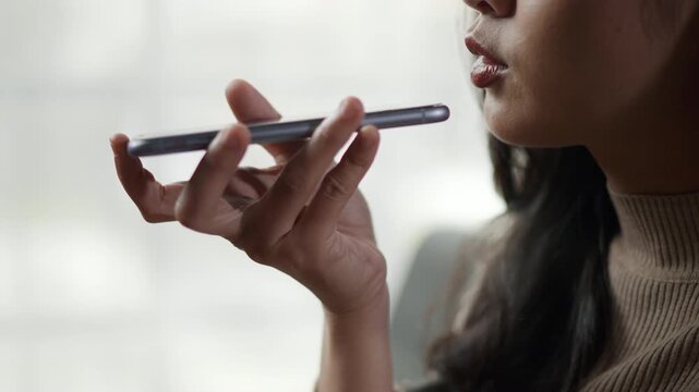 close up of woman mouth is talking and giggle with happy joy to smartphone on speakerphone with friends family or others colleague 