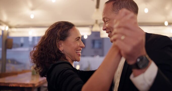 Happy couple, dancing together and dinner date in relationship for romantic connection. Married people, romance and affection in love, celebration and anniversary at restaurant for bonding or memeory