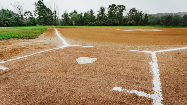a dirt baseball field view from behind home plate