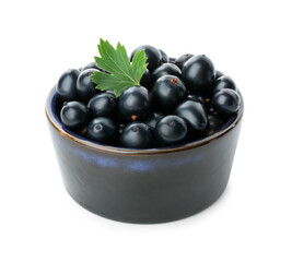 Bowl of ripe blackcurrants and green leaf isolated on white