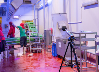 Measuring noise in line production with a sound level meter.