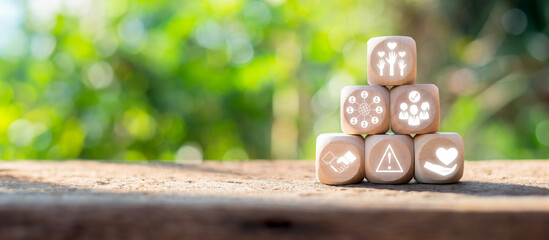 Wooden blocks with volunteer concept icons, symbolizing helping hands, community support, and...