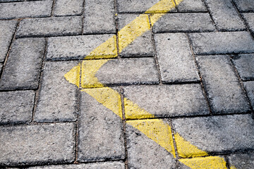 Yellow elbow line on paving stone