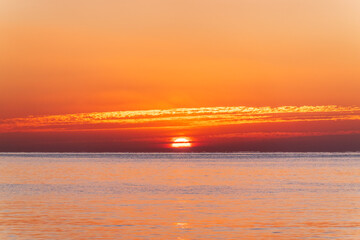 Fototapeta premium Beautiful red and orange sunrise over the sea.
