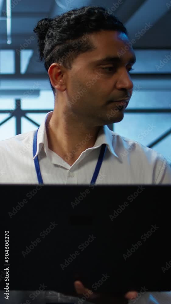 Poster vertical video system administrator in data center using notebook to design, implement and manage ge