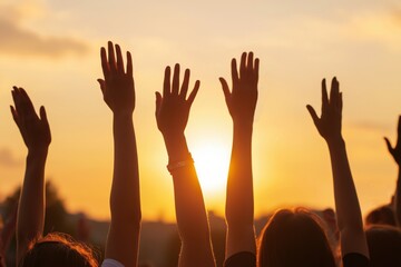 Hands to heaven, group of people with their hands up looking at the sunset	