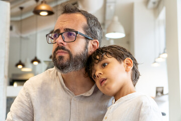 Father and son worried about bad news. Togetherness against war, disease and family problems concept.