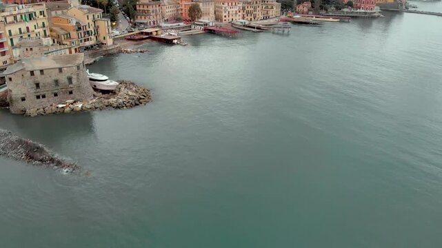 Aerial view of Carlo Riva Marina destroyed by powerful storm. Extreme disaster aftermath, sunken yachts and boats, piles of debris, catastrophic weather events damage. Rapallo, Italy.