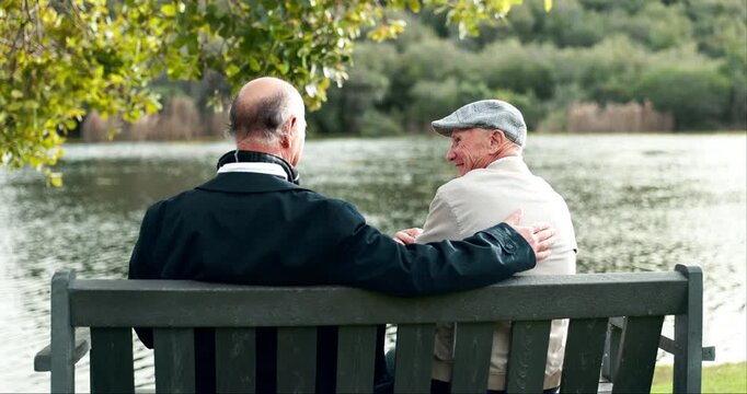 Discussion, senior men and park with support, story and care from news outdoor. Reunion, retirement and empathy of elderly friends back by a lake with communication, chat and kindness of friendship