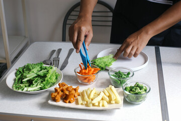 Preparing Delicious Food With Plating Vegetable Using Clamp On White Table