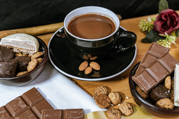 Chocolate chip cookies, dark and white chocolate bar, small bowl of oatmeal and nuts. International Chocolate Day.