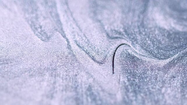 Liquid silver texture. Shimmer ink flow. Defocused gray color metallic glitter sand particles sparkling paint fluid spill motion abstract art background.