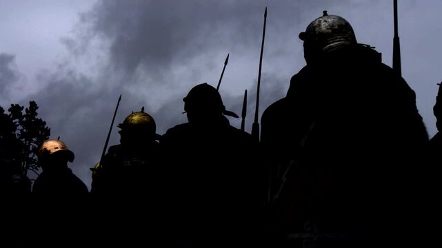 Silhouetted warriors with spears under twilight sky, evoking ancient battles and epic conflicts