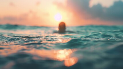 Obraz premium A swimmer enjoys the tranquil ocean as the sun sets, casting warm colors across the sky