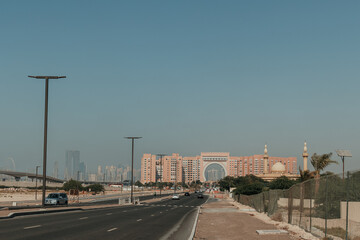 Dubai, UAE - October 6, 2020: Oaks Ibn Battuta Gate hotel building architecture with cityscape and road surroundings 